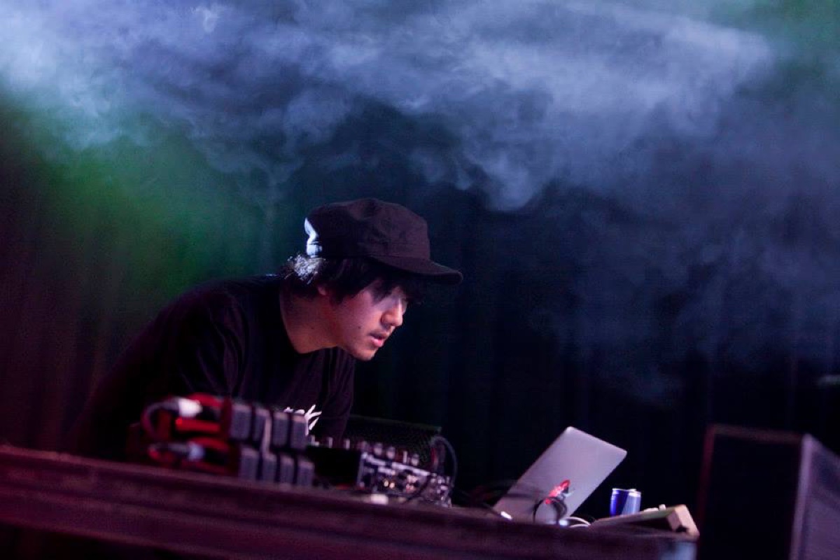 Emufucka performing behind equipment in stage smoke